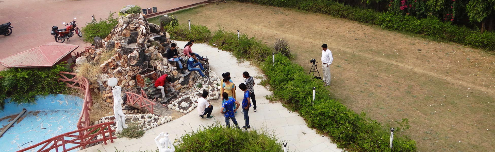 High-angle wide shot of the Trisna Films production crew, camera operator on tripod, and cast on set during an outdoor music video shoot in India. film production house in Bemetara, video production house in Bemetara, tv production house in Bemetara, production house in Bemetara, film production company in Bemetara, video production company in Bemetara, tv production company in Bemetara, production company in Bemetara