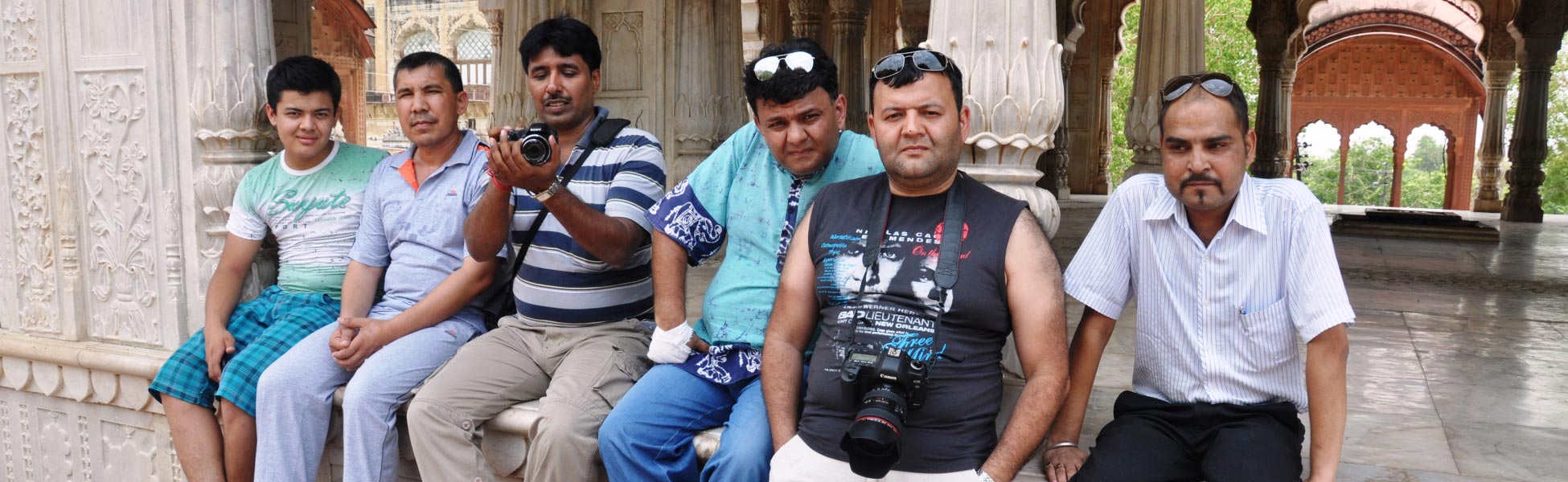 Joint Indo-Uzbek music video cast and crew sitting on the white marble pavilion terrace of Moosi Maharani Ki Chhatri in Alwar, Rajasthan during a line production shoot by Trisna Films. fixer in Bhadradri Kothagudem, film fixer in Bhadradri Kothagudem, media fixer in Bhadradri Kothagudem, movie fixer in Bhadradri Kothagudem, production fixer in Bhadradri Kothagudem, line producer in Bhadradri Kothagudem