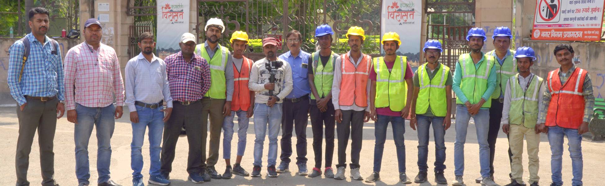 Trisna Films® and Neev Energy crew members, wearing safety gear and holding camera equipment, posing together during a corporate video production shoot for the Prayagraj Smart City project in Prayagraj, Uttar Pradesh, India. film production house in Nawada, video production house in Nawada, tv production house in Nawada, production house in Nawada, film production company in Nawada, video production company in Nawada, tv production company in Nawada, production company in Nawada