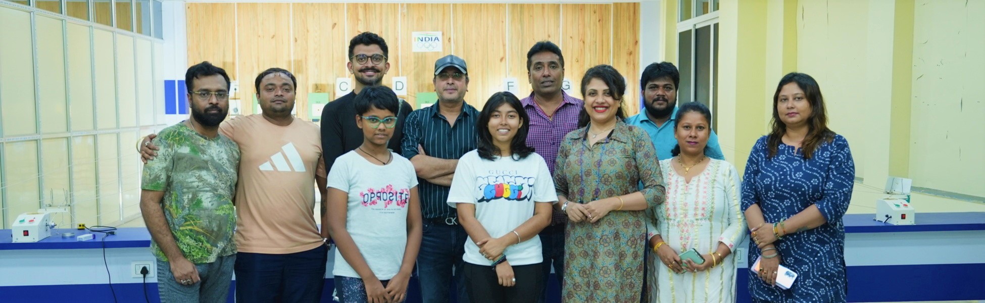 Group photo of the Trisna Films crew at a shooting range facility in Kolkata, West Bengal, India, during the documentary film production for IOC Young Leader Rishav Bhowmik. film shooting locations in Nawada, video shooting locations in Nawada, tv shooting locations in Nawada, shooting locations in Nawada