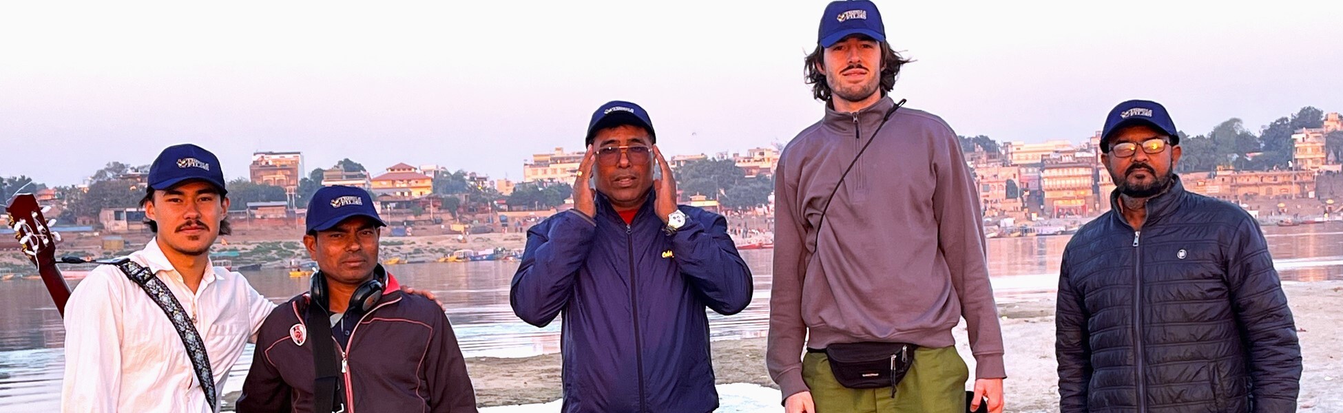 International documentary film production crew from Trisna Films and the Netherlands on location in Varanasi, India, with historic ghats in the background. filmmaking workshop in india, filmmaking workshop in delhi, filmmaking workshop in mumbai, filmmaking workshop in pune, filmmaking workshop in sonipat, filmmaking workshop in begusarai, cinematography workshop in india, cinematography workshop in delhi, cinematography workshop in mumbai, cinematography workshop in pune, cinematography workshop in sonipat, cinematography workshop in begusarai, camera workshop in india, camera workshop in delhi, camera workshop in mumbai, camera workshop in pune, camera workshop in sonipat, camera workshop in begusarai, editing workshop in india, editing workshop in delhi, editing workshop in mumbai, editing workshop in pune, editing workshop in sonipat, editing workshop in begusarai, vfx workshop in india, vfx workshop in Delhi, vfx workshop in mumbai, vfx workshop in pune, vfx workshop in sonipat, vfx workshop in begusarai, animation workshop in india, animation workshop in Delhi, animation workshop in mumbai, animation workshop in pune, animation workshop in sonipat, animation workshop in begusarai, photography workshop in india, photography workshop in delhi, photography workshop in mumbai, photography workshop in pune, photography workshop in sonipat, photography workshop in begusarai, direction workshop in india, direction workshop in delhi, direction workshop in mumbai, direction workshop in pune, direction workshop in sonipat, direction workshop in begusarai, script writing workshop in india, script writing workshop in delhi, script writing workshop in mumbai, script writing workshop in pune, script writing workshop in sonipat, script writing workshop in begusarai