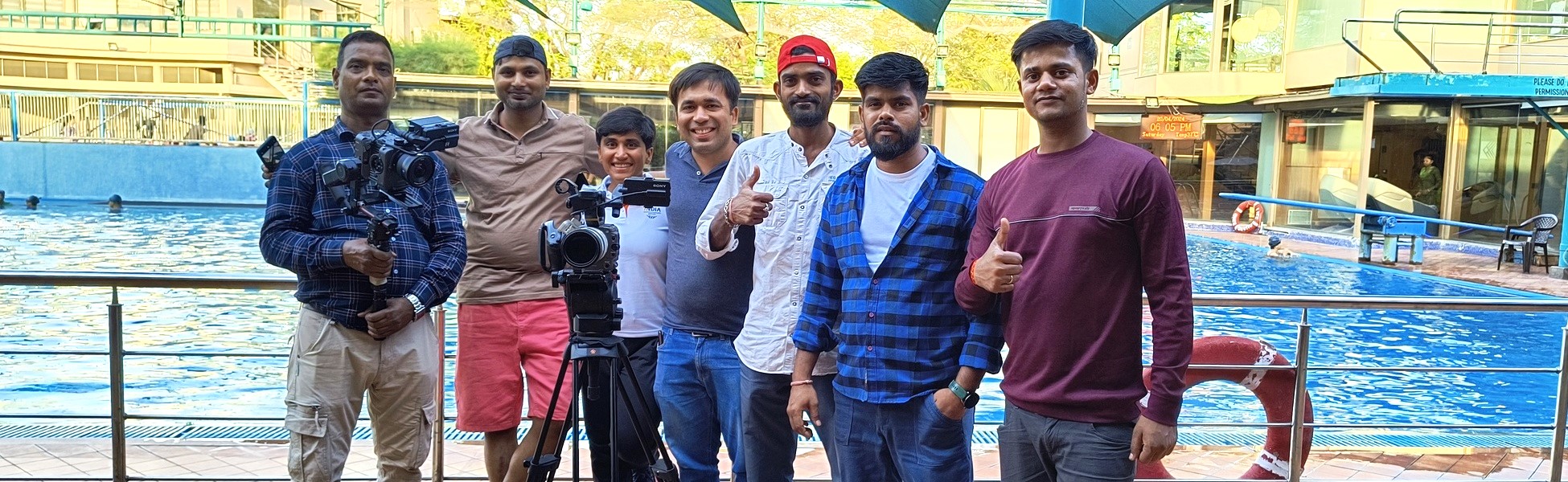 The Trisna Films® production crew standing with professional camera equipment by an outdoor swimming pool in Ahmedabad, Gujarat, during the filming of the IOC Young Leaders documentary featuring Pragnya Mohan. animation film production house in bihar, animation film production house in begusarai, animation video production house in bihar, animation video production house in begusarai, animation production house in bihar, animation production house in begusarai, animation film production company in bihar, animation film production company in begusarai, animation video production company in bihar, animation video production company in begusarai, animation production company in bihar, animation production company in begusarai