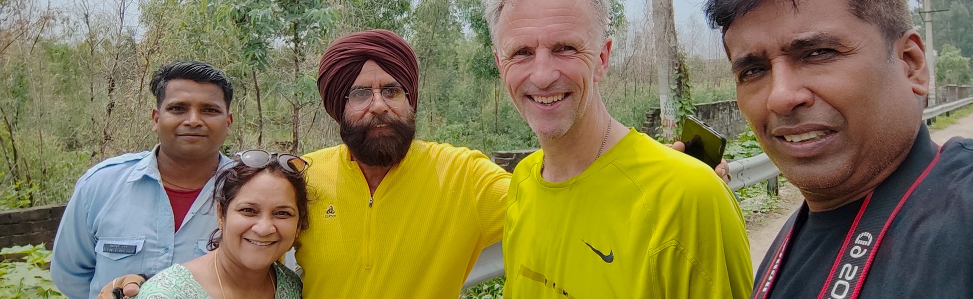 Dr. Edo de Vette from the Netherlands posing with cyclist Prof. Balwinder Singh Mohie and companions at the Ludhiana bypass, Punjab, India, during a documentary or travel project. filmmaking workshop in pune, cinematography workshop in pune, camera workshop in pune, editing workshop in pune, vfx workshop in pune, animation workshop in pune, photography workshop in pune, direction workshop in pune, script writing workshop in pune