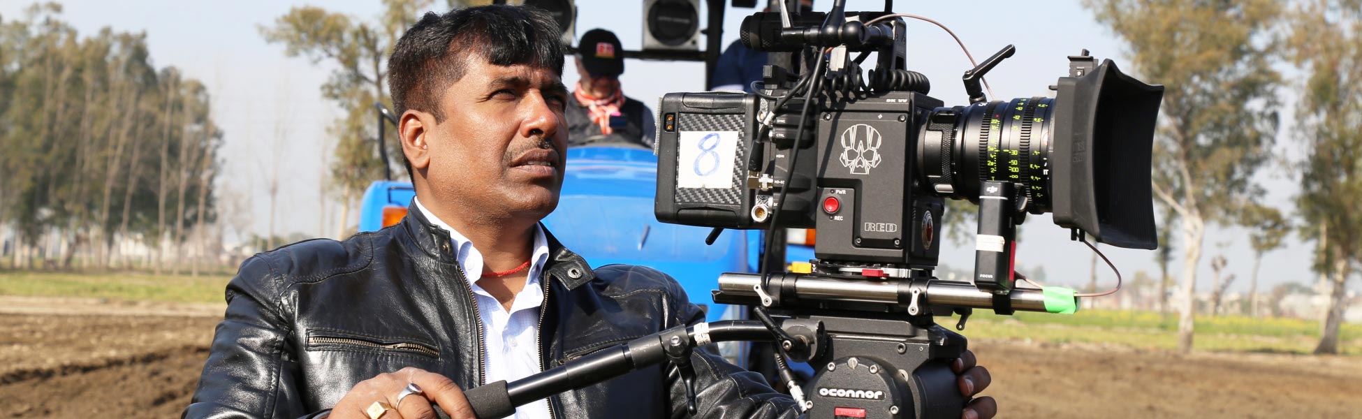 Cinematographer Avinash Kumar on the set of a web series in Ludhiana, Punjab, India. Behind-the-scenes view of a professional DOP managing a high-resolution digital cinema camera for an outdoor industrial or rural shoot. filmmaking workshop in india, cinematography workshop in india, camera workshop in india, editing workshop in india, vfx workshop in india, animation workshop in india, photography workshop in india, direction workshop in india, script writing workshop in india