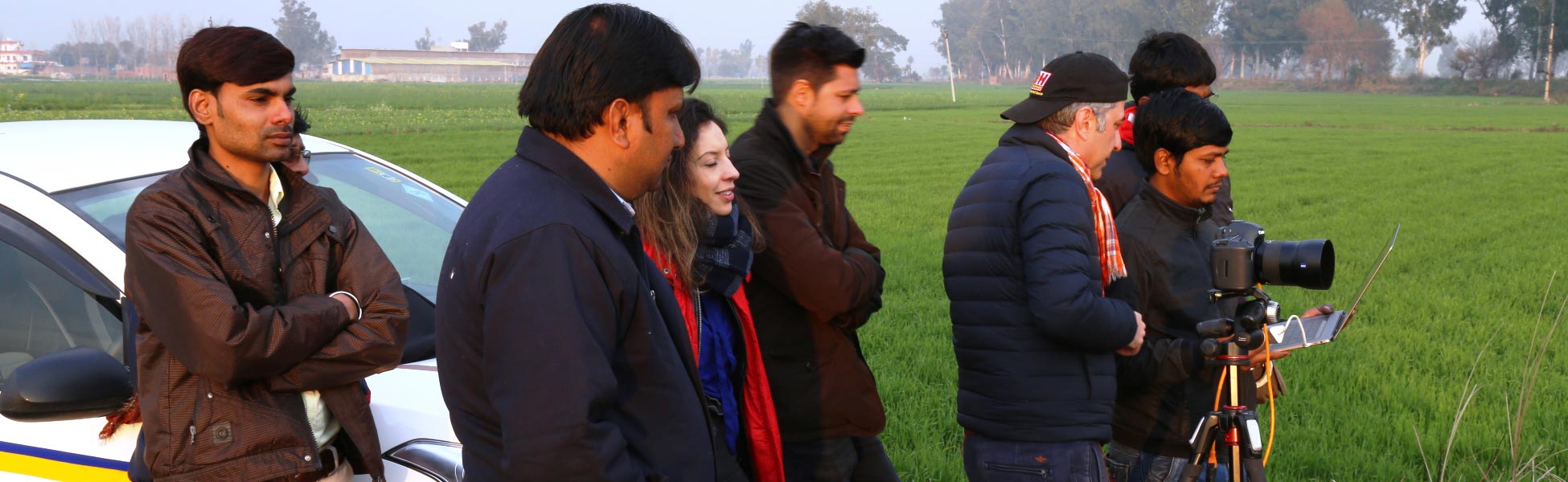 Behind the scenes of a web series production in Ludhiana, Punjab, showcasing the Trisna Films® technical crew and international clients collaborating on location in a green agricultural field. film shooting locations in india, film shooting locations in Delhi, film shooting locations in mumbai, film shooting locations in pune, film shooting locations in sonipat, film shooting locations in begusarai, video shooting locations in india, video shooting locations in Delhi, video shooting locations in mumbai, video shooting locations in pune, video shooting locations in sonipat, video shooting locations in begusarai, tv shooting locations in india, tv shooting locations in delhi, tv shooting locations in mumbai, tv shooting locations in pune, tv shooting locations in sonipat, tv shooting locations in begusarai, shooting locations in india, shooting locations in delhi, shooting locations in mumbai, shooting locations in pune, shooting locations in sonipat, shooting locations in begusarai
