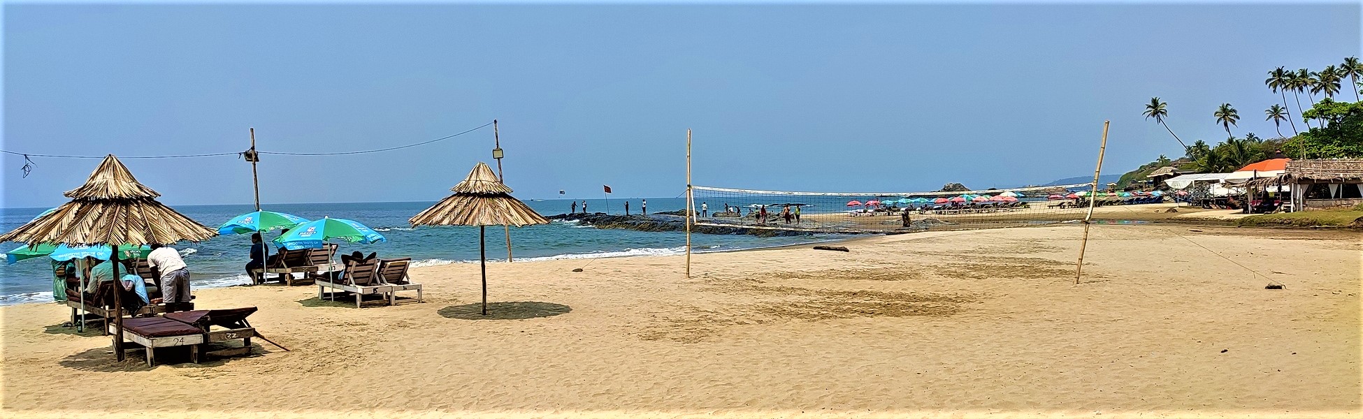 Panoramic view of Vagator Beach in Goa, featuring the shoreline and beach shacks; a premier coastal film shooting location managed by Trisna Films® expert line producers since 2000. film production house in india, video production house in india, tv production house in india, production house in india, film production company in india, video production company in india, tv production company in india, production company in india