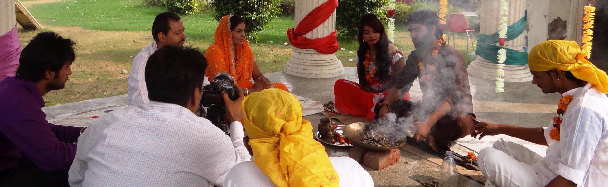 Film crew and actors on the set of 'Andhvishwas' short film in Delhi, India, capturing a traditional ritual scene with a havan fire and professional camera equipment. film production house in Bagalkot, video production house in Bagalkot, tv production house in Bagalkot, production house in Bagalkot, film production company in Bagalkot, video production company in Bagalkot, tv production company in Bagalkot, production company in Bagalkot