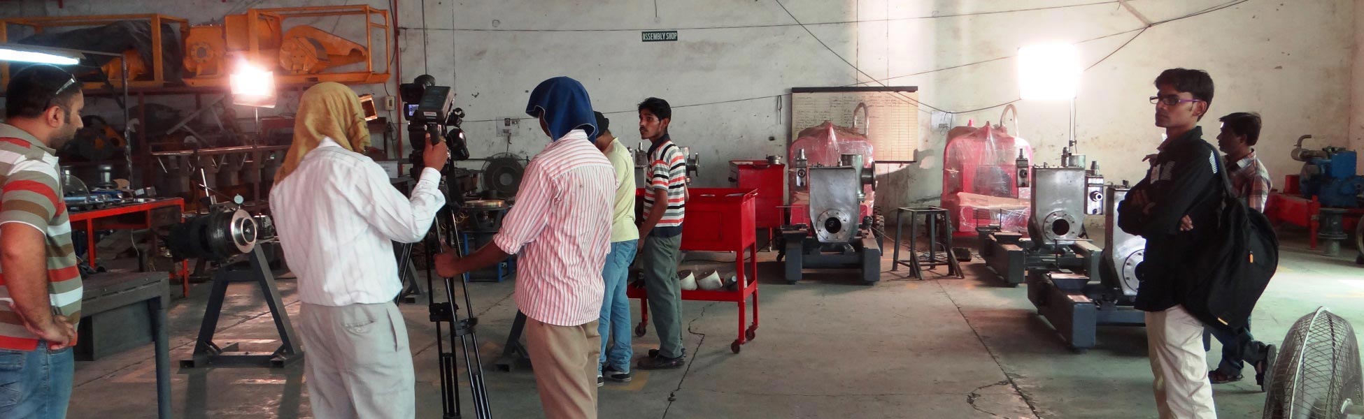 Professional video production crew filming a corporate documentary inside an industrial manufacturing factory assembly shop in Ludhiana, Punjab, featuring cameras, lighting equipment, and machinery. fixer in Baksa, fixer in mushalpur, film fixer in baksa, film fixer in mushalpur, media fixer in baksa, media fixer in mushalpur, movie fixer in baksa, movie fixer in mushalpur, production fixer in baksa, production fixer in mushalpur, line producer in Baksa